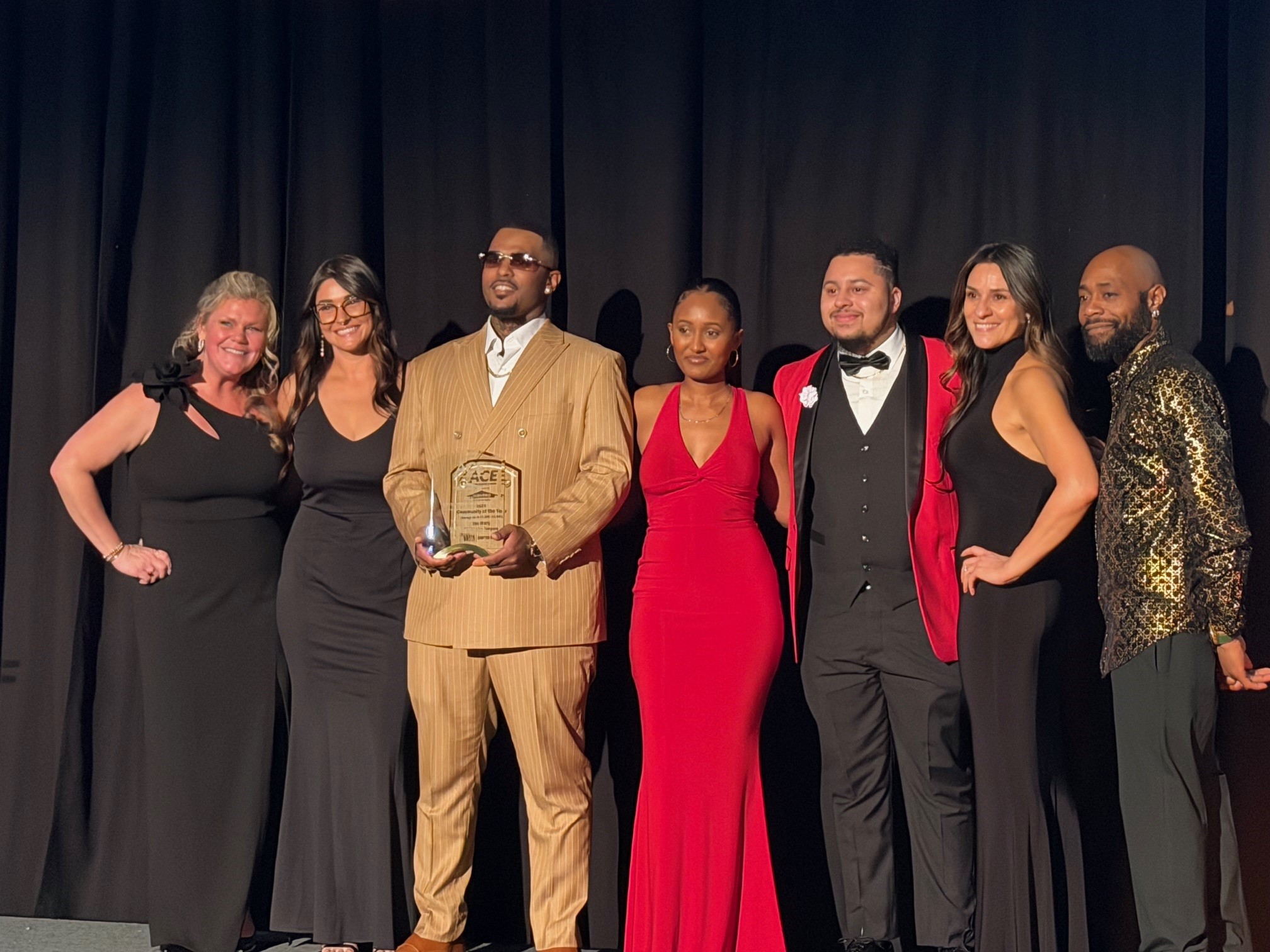 Group of Breeden Employees accepting an ACE award on stage